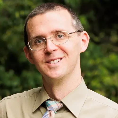 Photo of Homer Smith, wearing glasses, shirt, and tie.